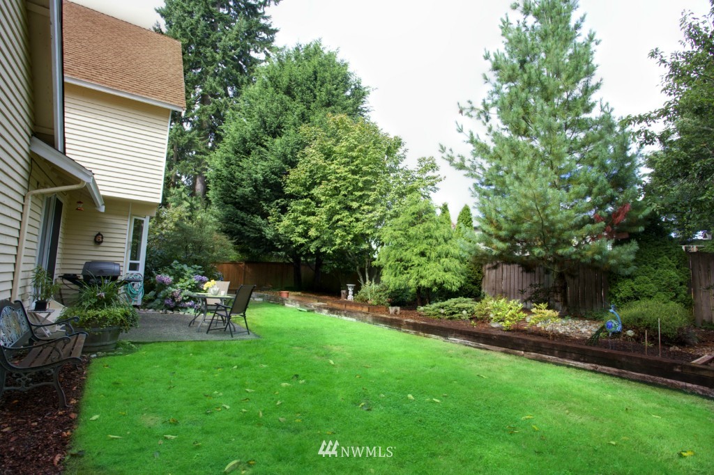 2517 166th Place Southeast Bothell, WA 98012 - Photo 16 of 20 a view of a chair and table in backyard of the house