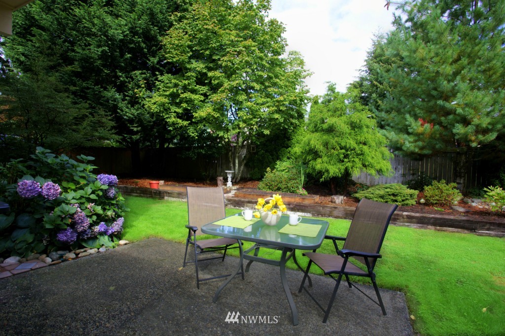2517 166th Place Southeast Bothell, WA 98012 - Photo 18 of 20 a backyard with table and chairs plants and trees