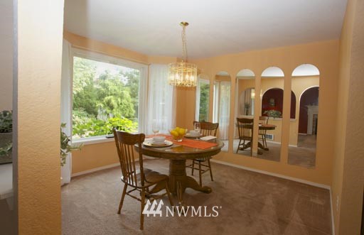 2517 166th Place Southeast Bothell, WA 98012 - Photo 6 of 20 a view of a dining room with furniture window and outside view