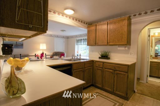 2517 166th Place Southeast Bothell, WA 98012 - Photo 7 of 20 a kitchen with stainless steel appliances granite countertop a sink and cabinets