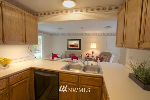 2517 166th Place Southeast Bothell, WA 98012 - Photo 8 of 20 a kitchen with a sink cabinets and potted plant