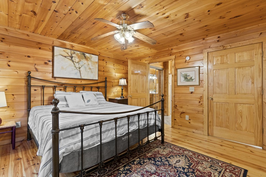 96 Holiday Court Ellijay, GA 30540 - Photo 23 of 51 a bedroom with a bed a mirror and shower
