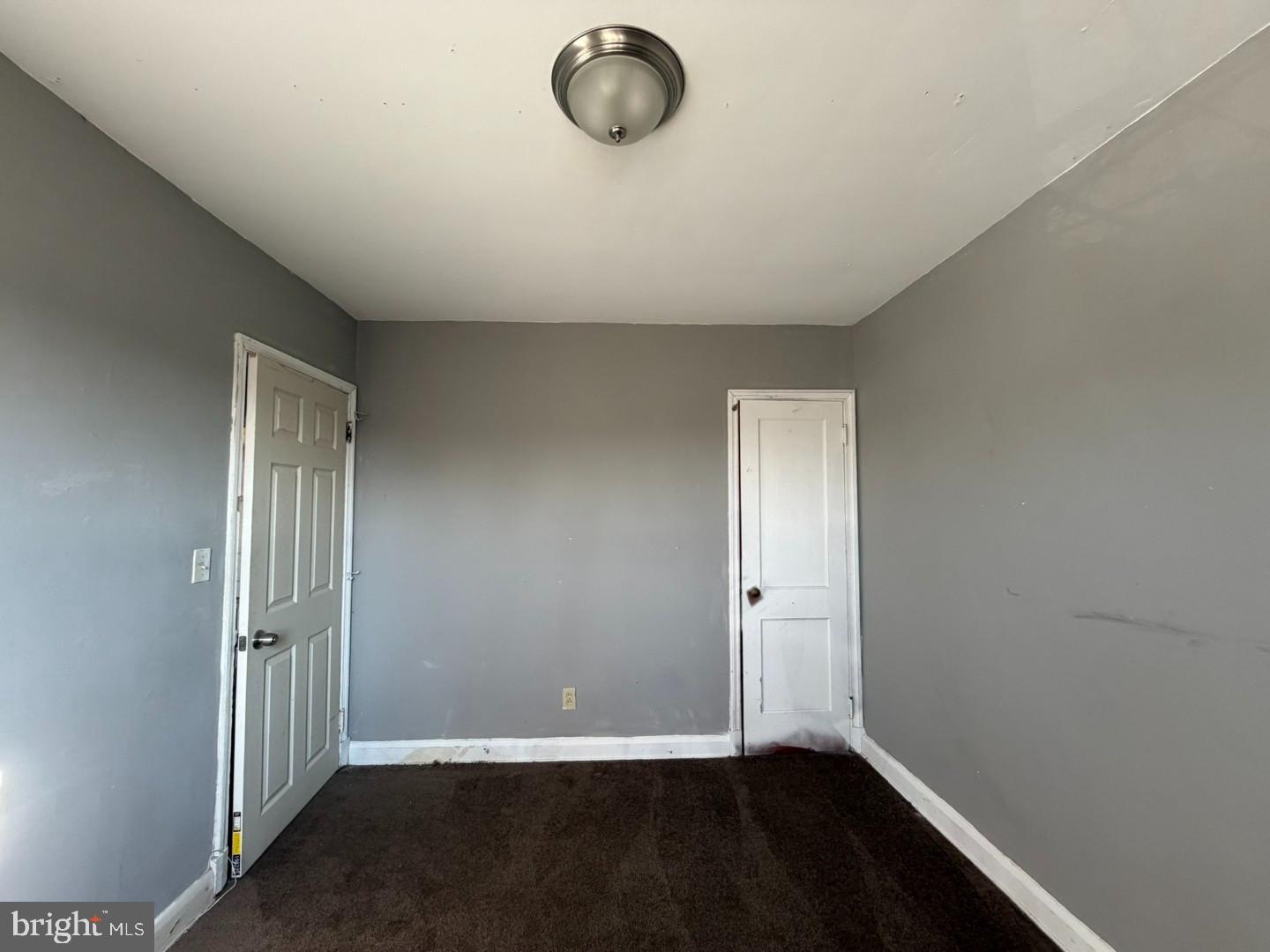 4027 Raymonn Avenue Baltimore, MD 21213 - Photo 15 of 19 an empty room with wooden floor and windows