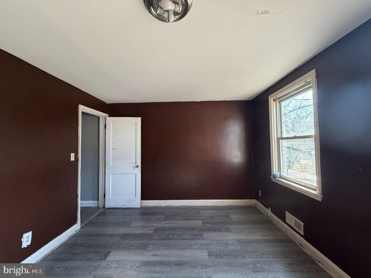 4027 Raymonn Avenue Baltimore, MD 21213 - Photo 5 of 19 an empty room with wooden floor and windows