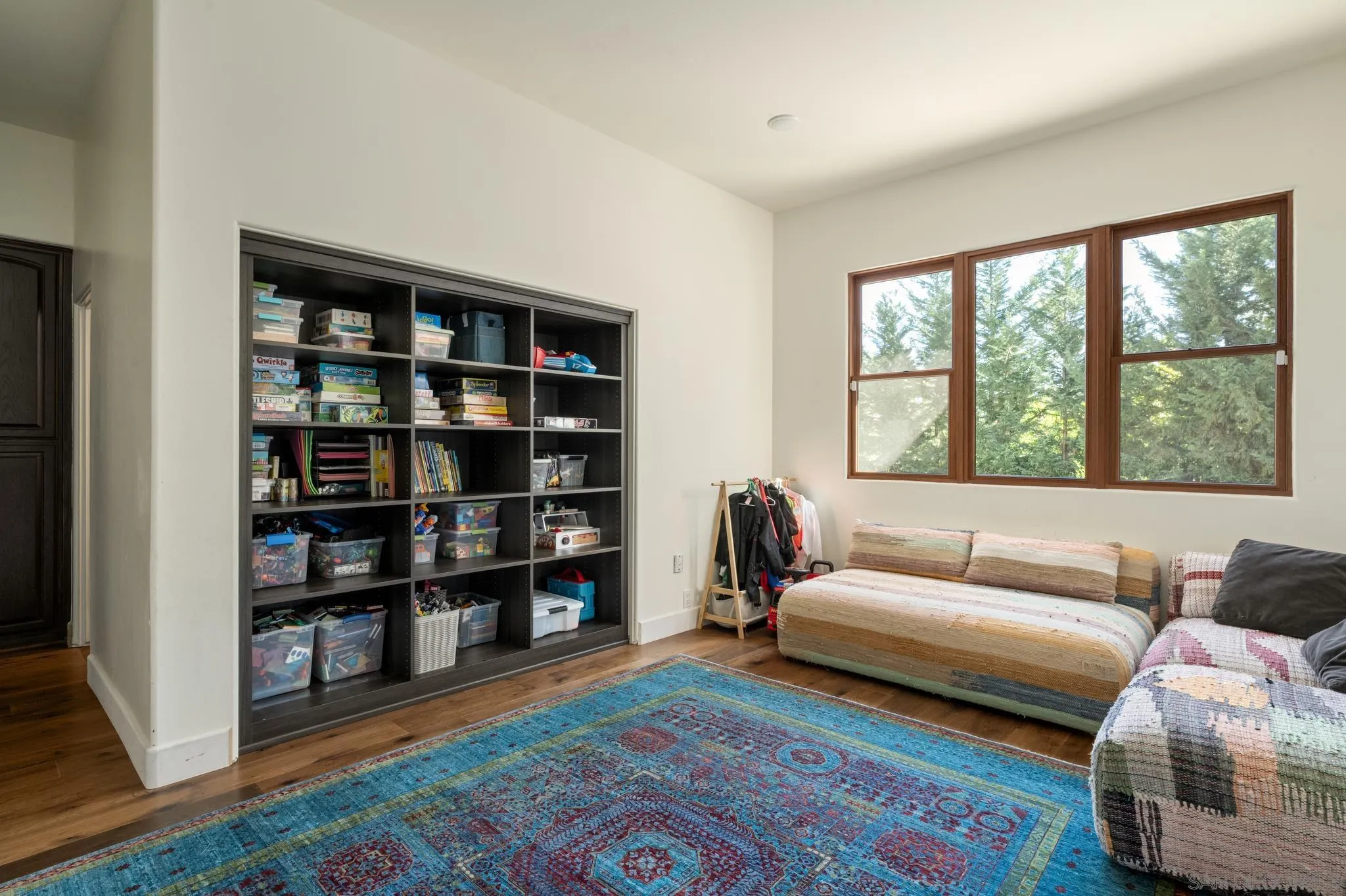 3028 Paseo Cielo Rancho Santa Fe, CA 92024 - Photo 27 of 50 a living room with furniture and a book shelf