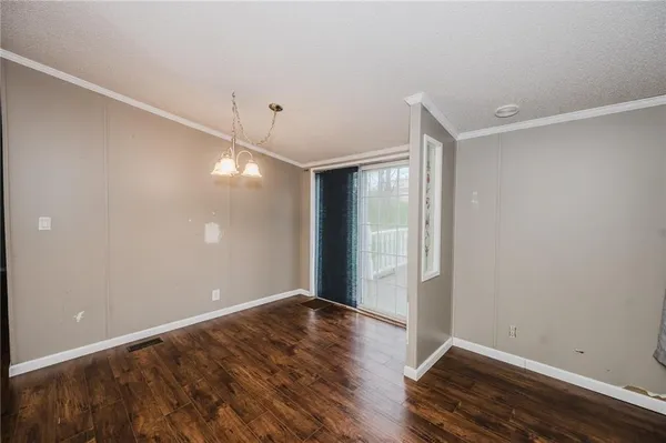 a view of room with window and wooden floor