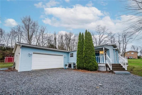 a view of a house with a yard and garage