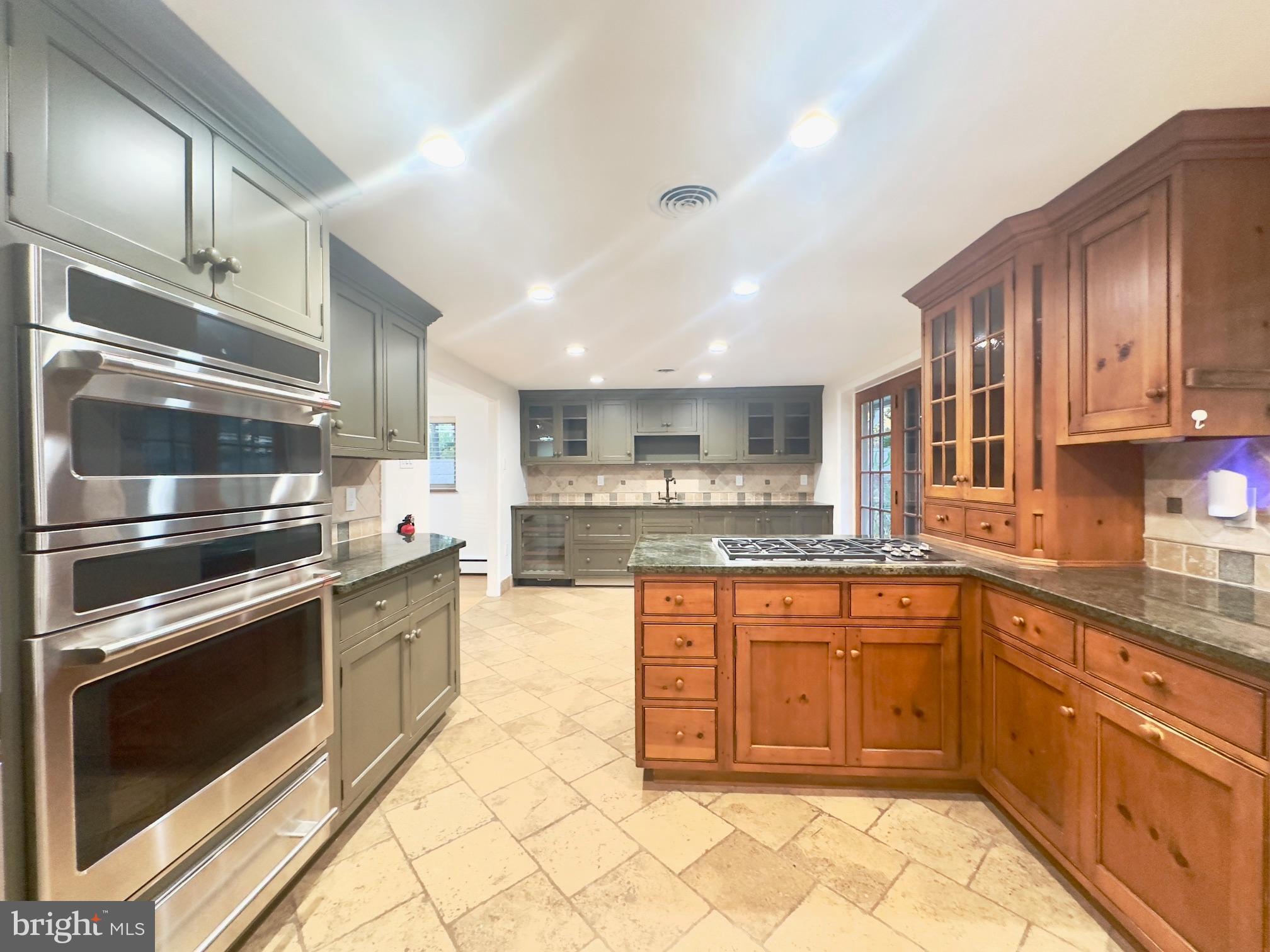 a kitchen with stainless steel appliances granite countertop a stove top oven microwave and cabinets