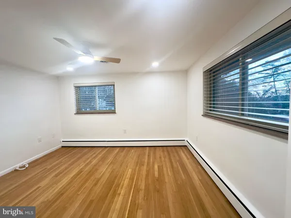 a view of a room with wooden floor and window
