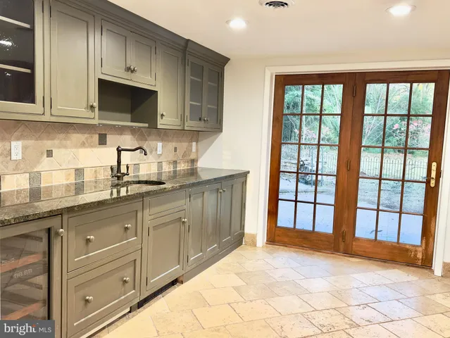 a kitchen with stainless steel appliances granite countertop a stove and a sink