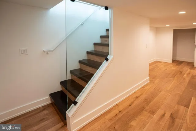 a view of entryway and hall with wooden floor