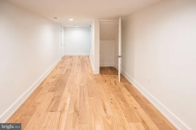a view of a room with wooden floor