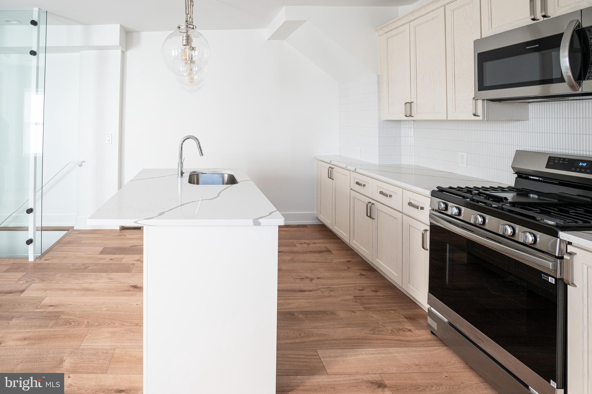 2538 East County Line Road, Unit 1 Ardmore, PA 19003 - Photo 4 of 16 a kitchen with a sink stove and microwave