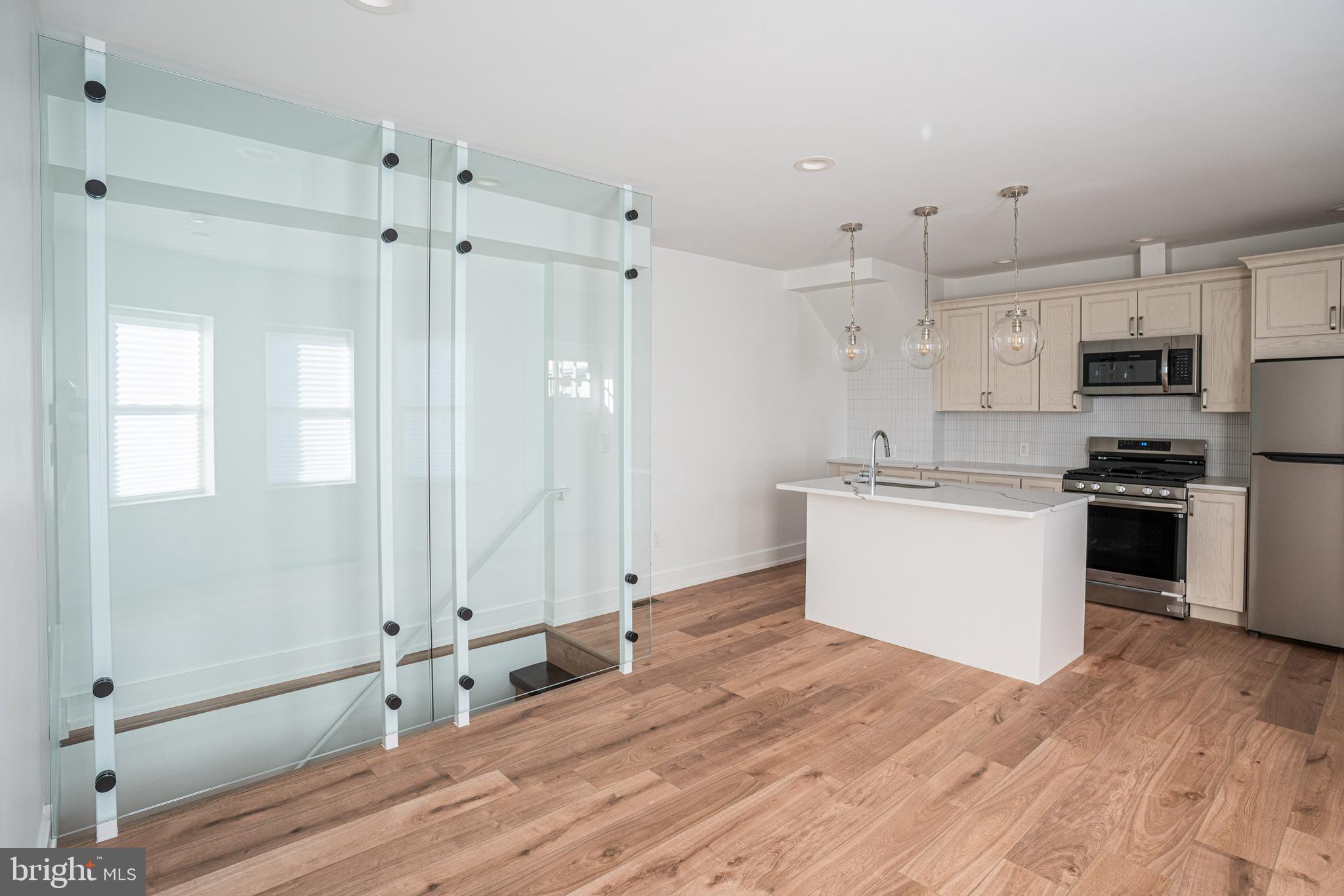2538 East County Line Road, Unit 1 Ardmore, PA 19003 - Photo 6 of 16 a kitchen with stainless steel appliances a refrigerator sink and white cabinets