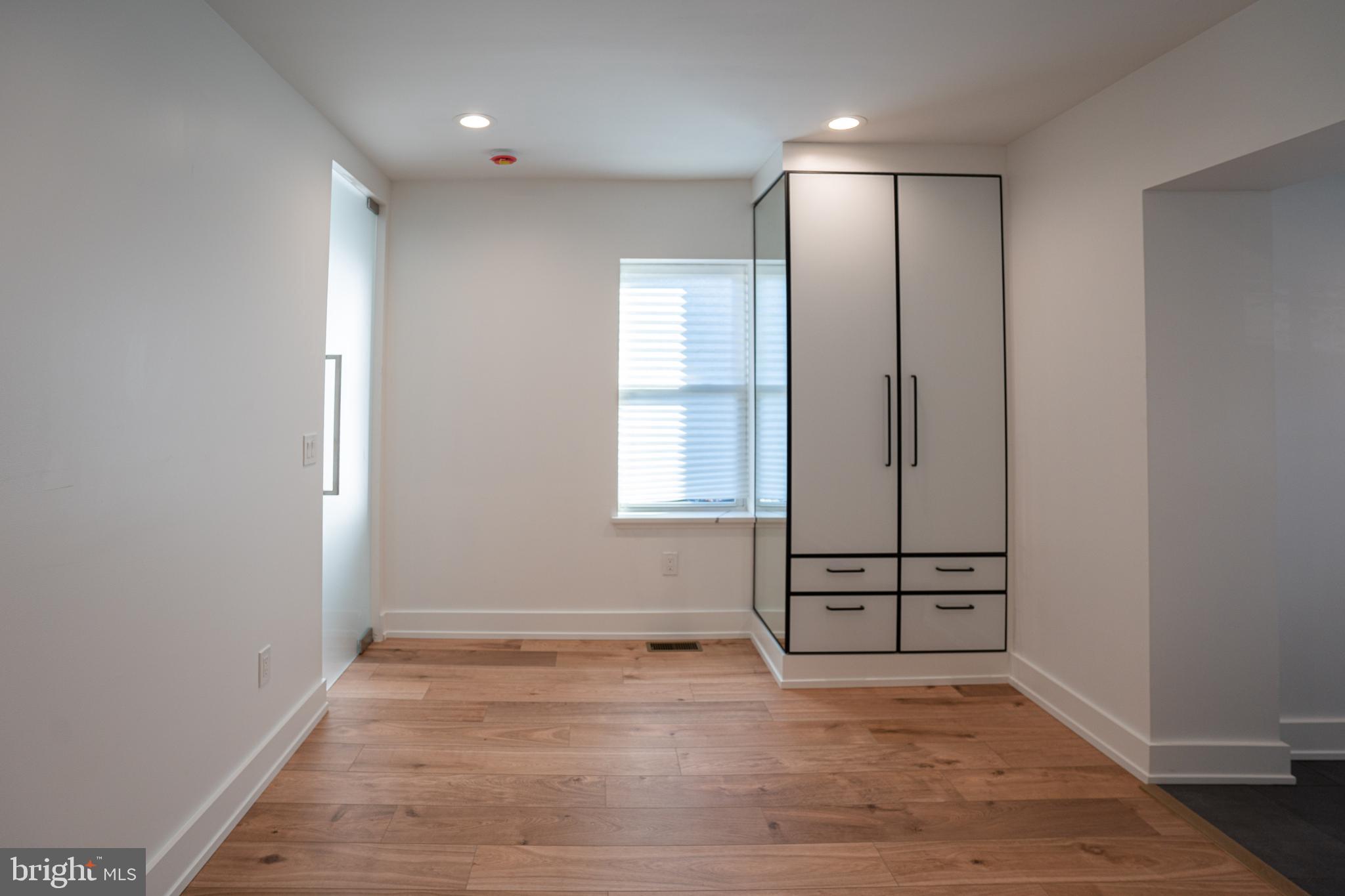 2538 East County Line Road, Unit 1 Ardmore, PA 19003 - Photo 8 of 16 an empty room with wooden floor and windows