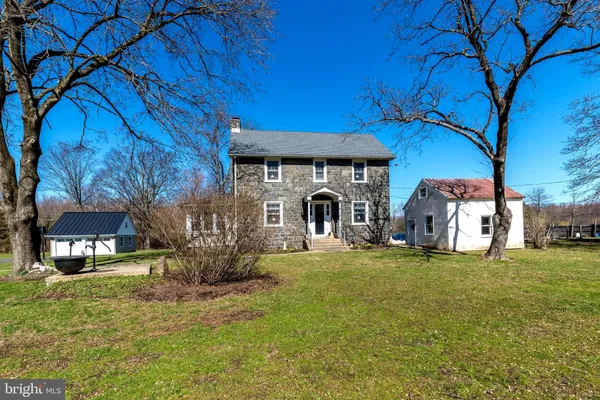 a front view of house with yard outdoor seating and barbeque oven