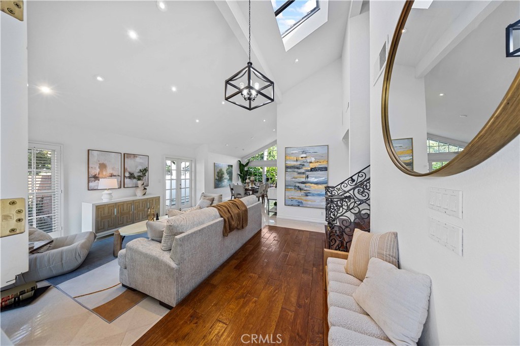 9 Hermosa Irvine, CA 92620 - Photo 5 of 20 a living room with furniture a mirror and a chandelier