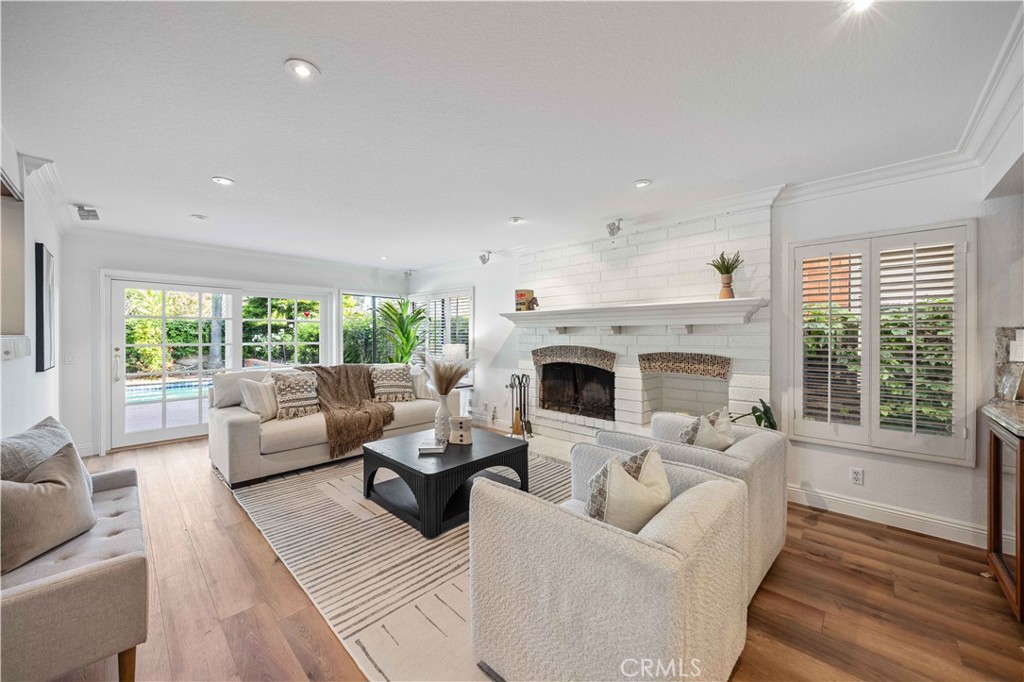9 Hermosa Irvine, CA 92620 - Photo 10 of 20 a living room with furniture a fireplace and a large window