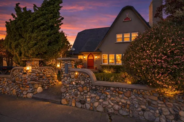 a view of a brick house with a yard