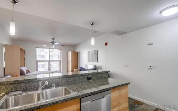 a kitchen with granite countertop a sink and a window