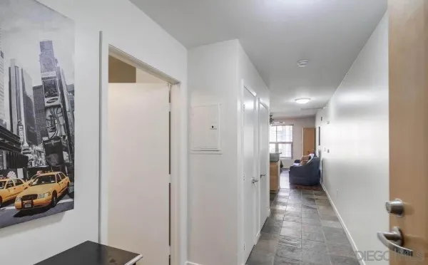 a view of a hallway with wooden floor