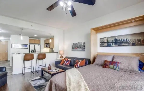a bedroom with furniture and a wooden floor