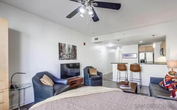 a living room with furniture a rug and a chandelier