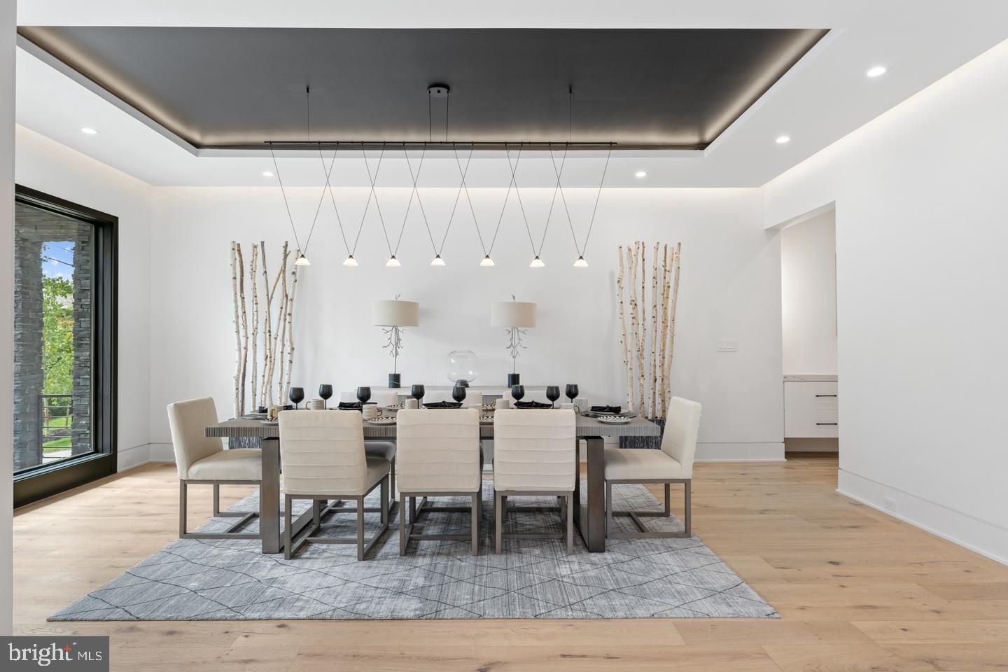 a dining room with furniture and wooden floor