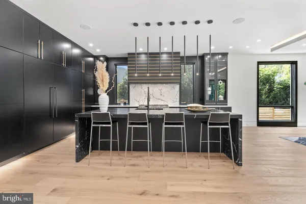 a kitchen with stainless steel appliances kitchen island granite countertop a stove a refrigerator and a sink