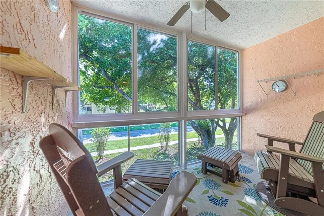 a living room with furniture and a floor to ceiling window
