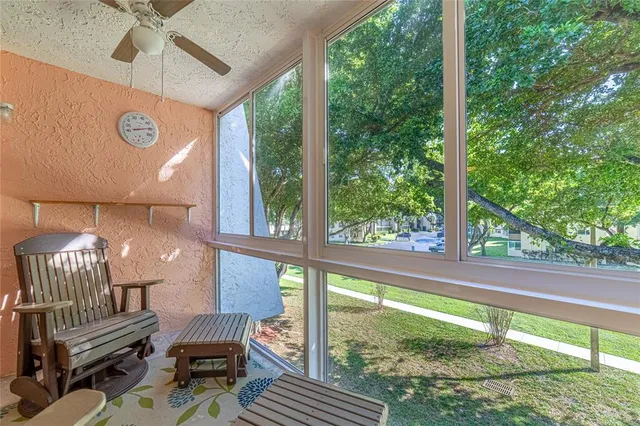 a view of a porch with chairs and backyard