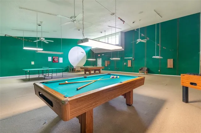 a room with pool table and windows