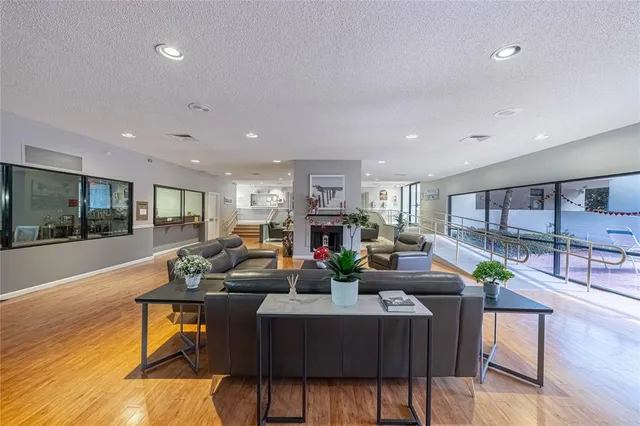 a living room with fireplace furniture and a wooden floor