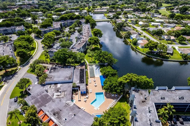an aerial view of house with yard swimming pool and outdoor seating