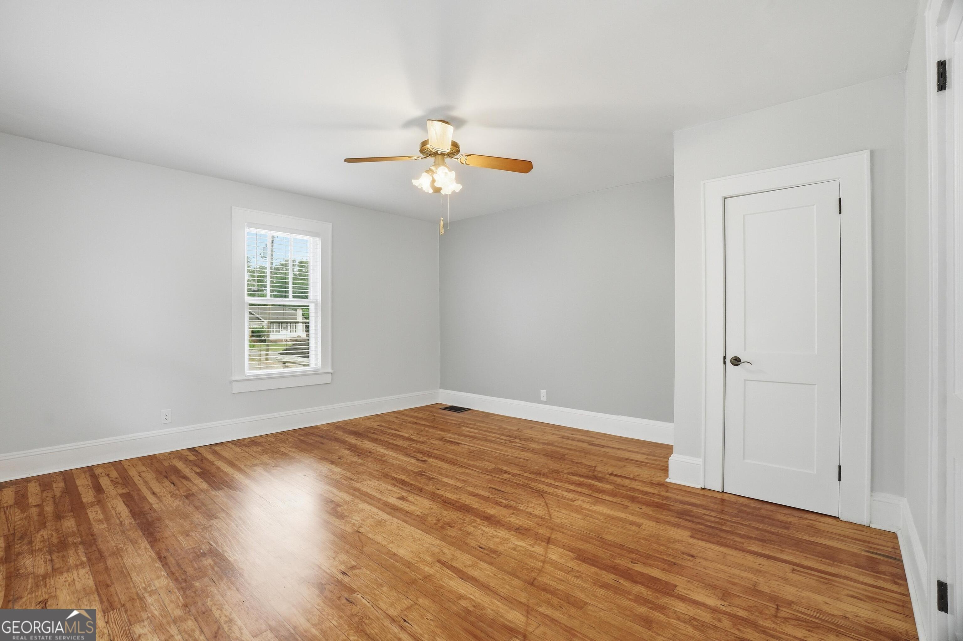 3022 Maple Road Southeast Lindale, GA 30147 - Photo 9 of 29 wooden floor in an empty room with a window