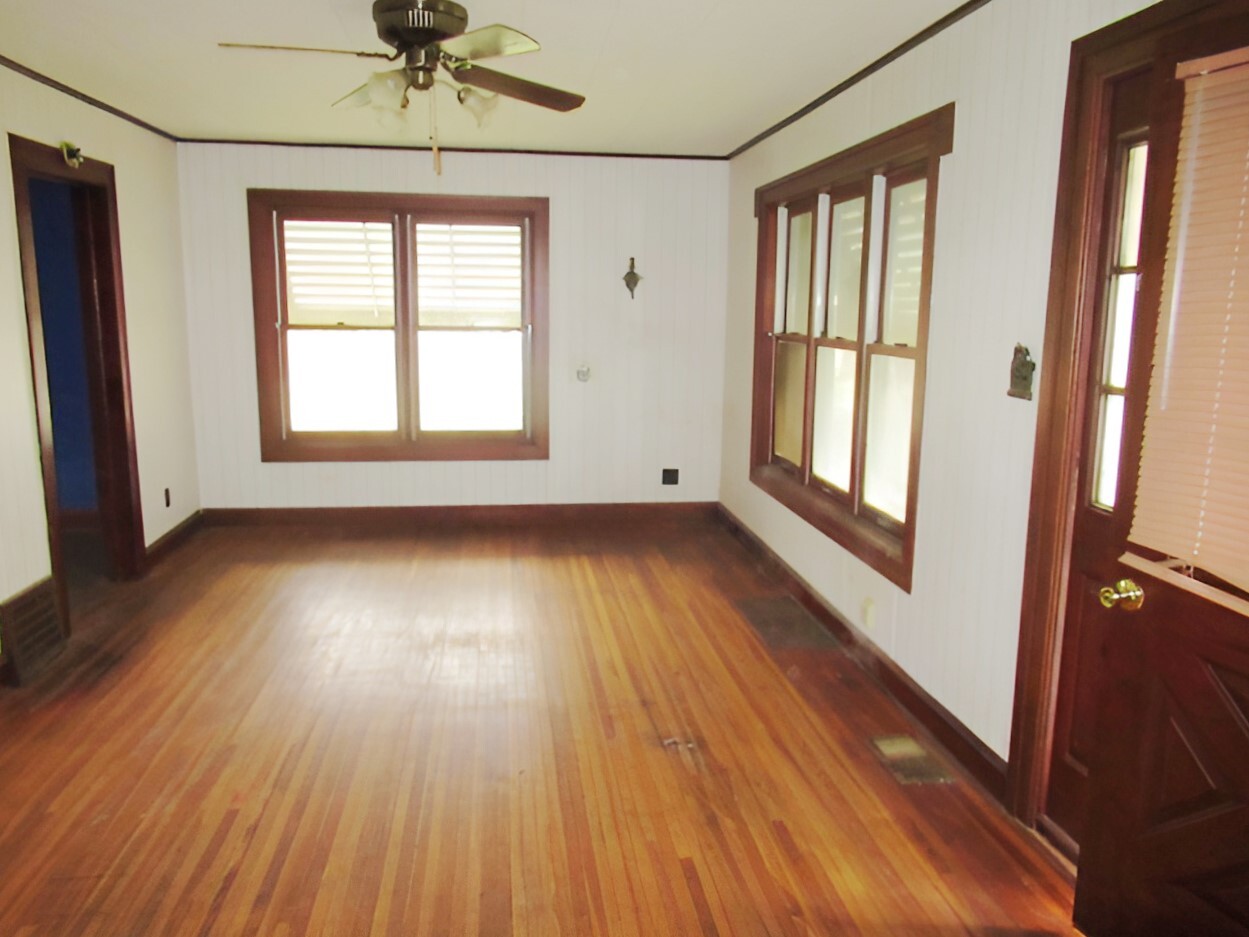 11 Dequimpal Street Westville, IL 61883 - Photo 7 of 21 an empty room with wooden floor and windows