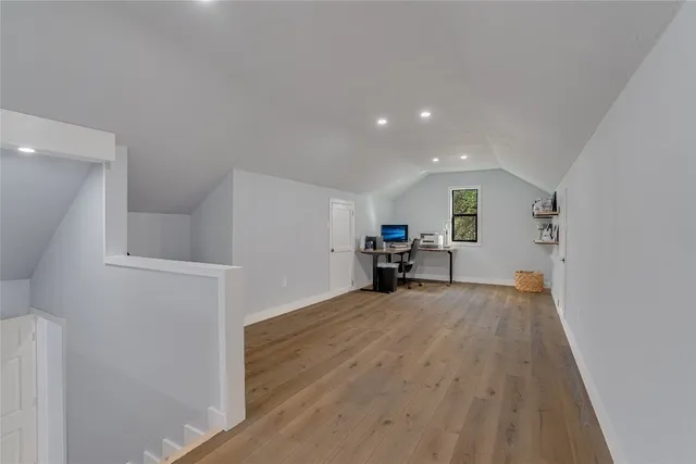 a view of empty room with wooden floor