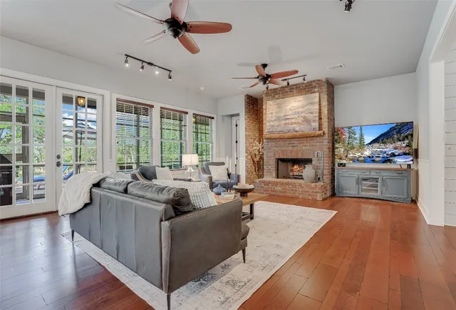 a living room with furniture fireplace and flat screen tv