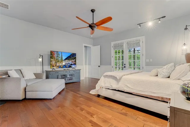 a living room with furniture a ceiling fan and a flat screen tv