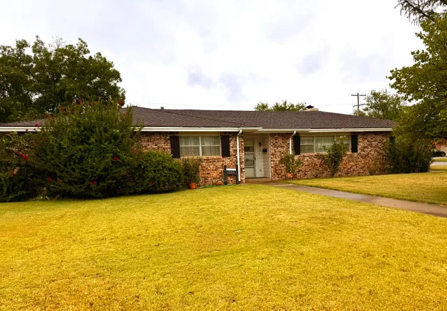 a front view of house with swimming pool and porch