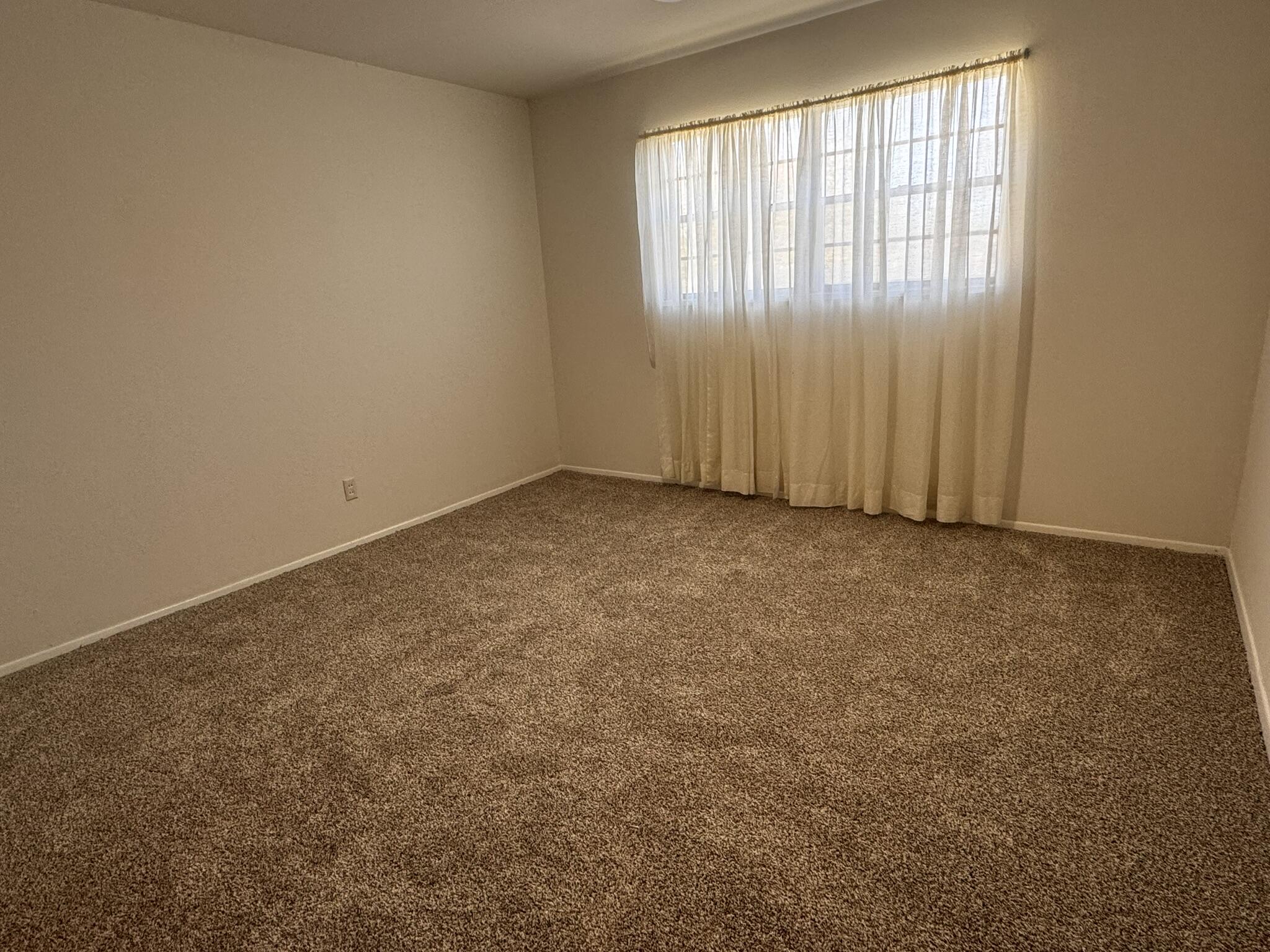 1209 Garland Plainview, TX 79072 - Photo 18 of 37 an empty room with windows