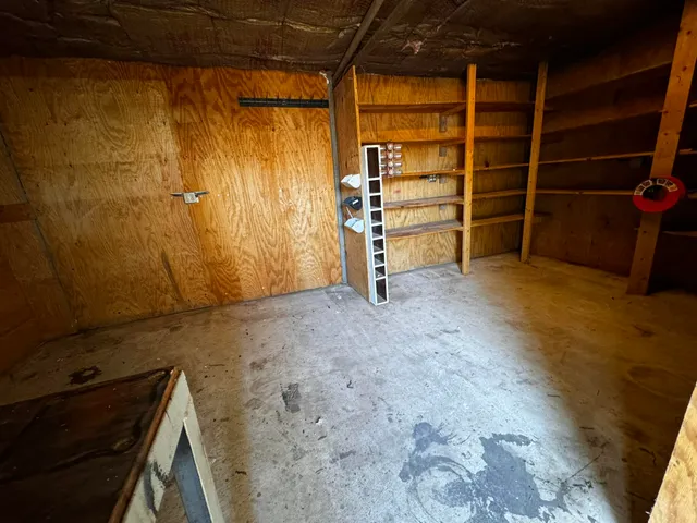 a view of a room with wooden walls and stairs