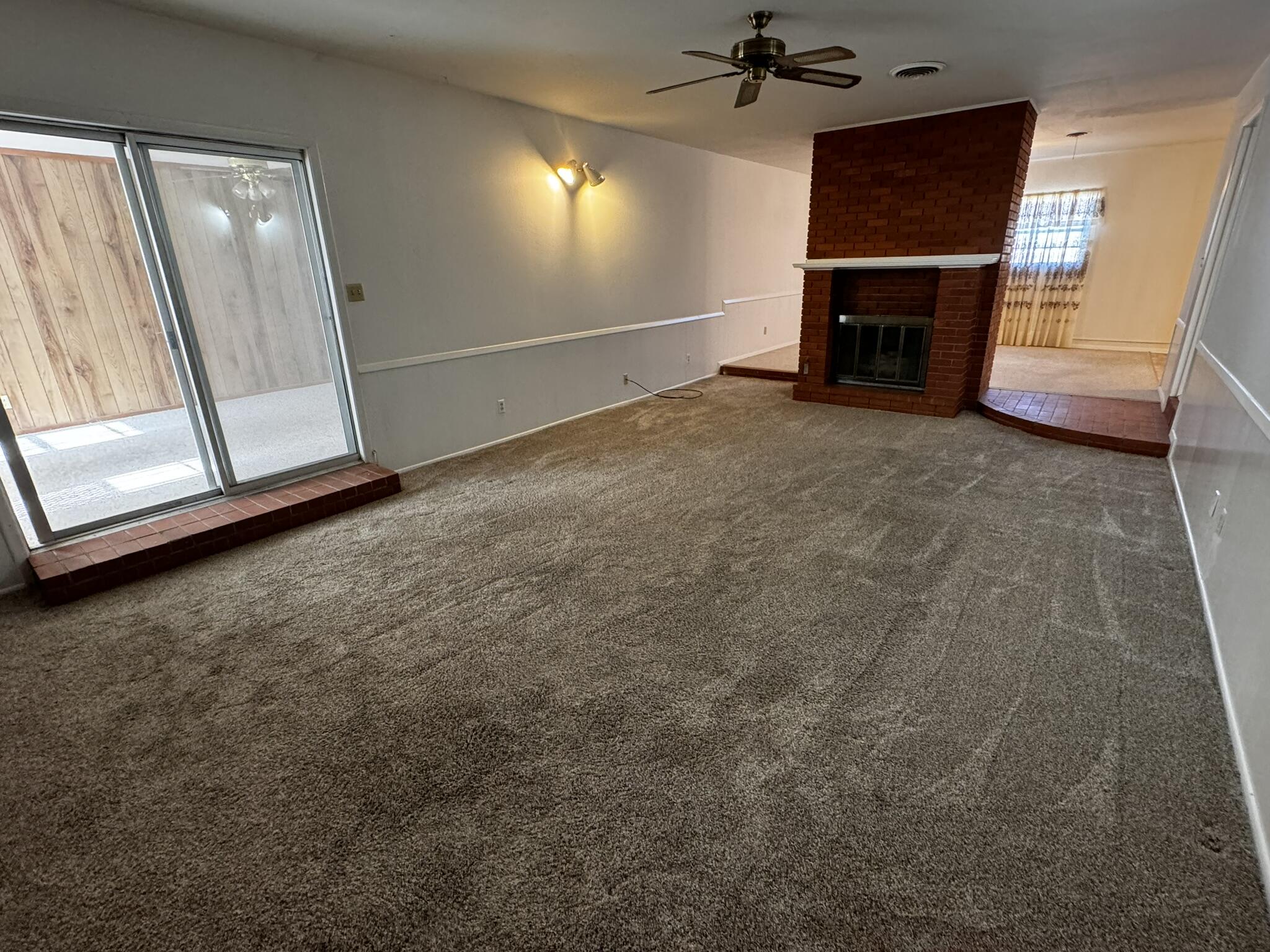 1209 Garland Plainview, TX 79072 - Photo 7 of 37 a view of an empty room with a fireplace and a window