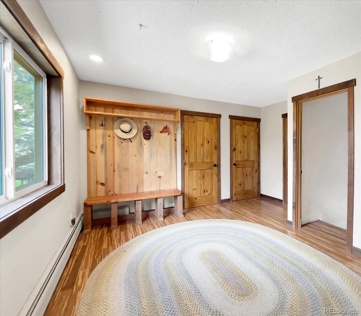22155 Cook Lane Morrison, CO 80465 - Photo 12 of 28 a spacious bedroom with a large bed and a window