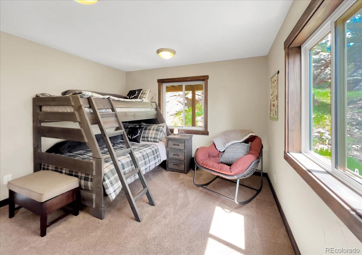 22155 Cook Lane Morrison, CO 80465 - Photo 13 of 28 a living room with furniture and a chair