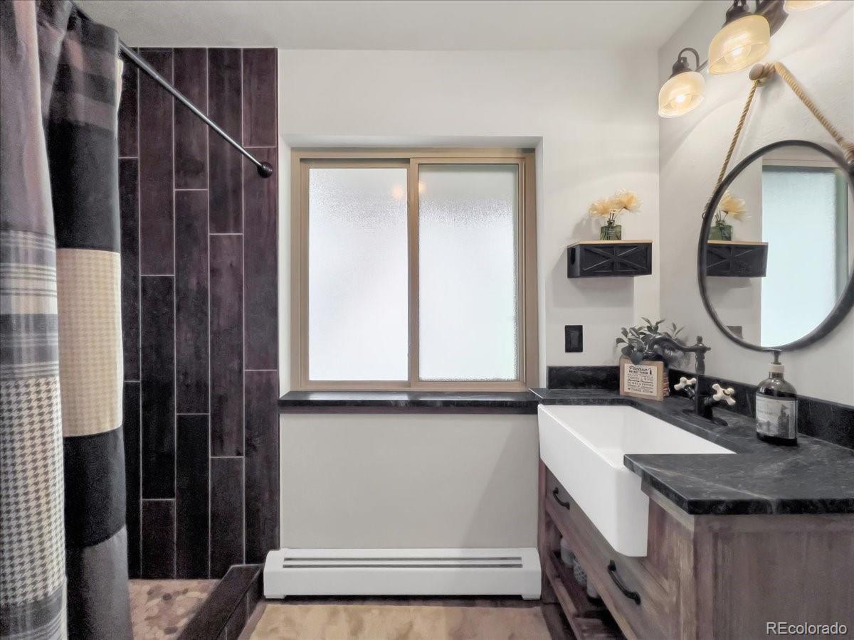 22155 Cook Lane Morrison, CO 80465 - Photo 18 of 28 a bathroom with a sink and a mirror