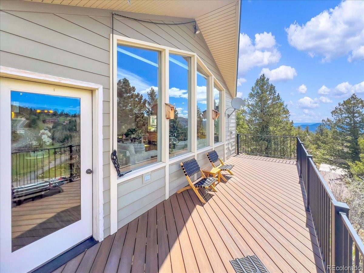 22155 Cook Lane Morrison, CO 80465 - Photo 24 of 28 a balcony with furniture and wooden floor