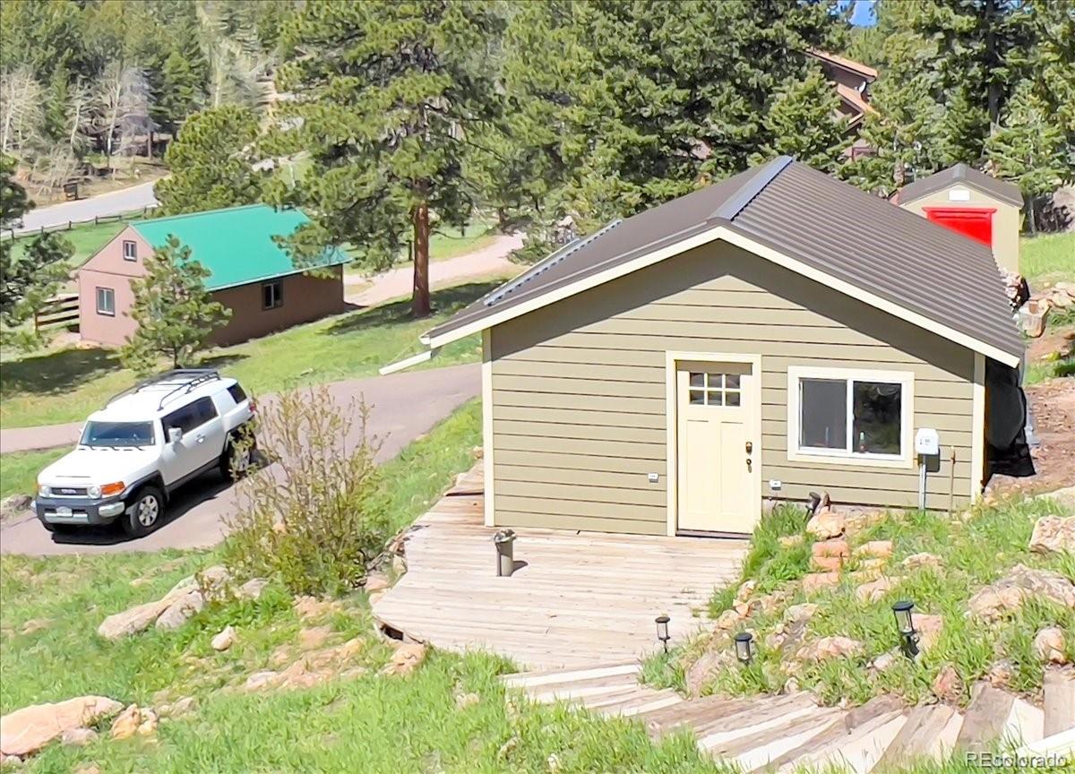 22155 Cook Lane Morrison, CO 80465 - Photo 25 of 28 a view of a house with a yard