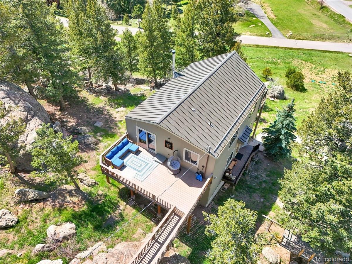 22155 Cook Lane Morrison, CO 80465 - Photo 28 of 28 an aerial view of house with yard and trees in the background