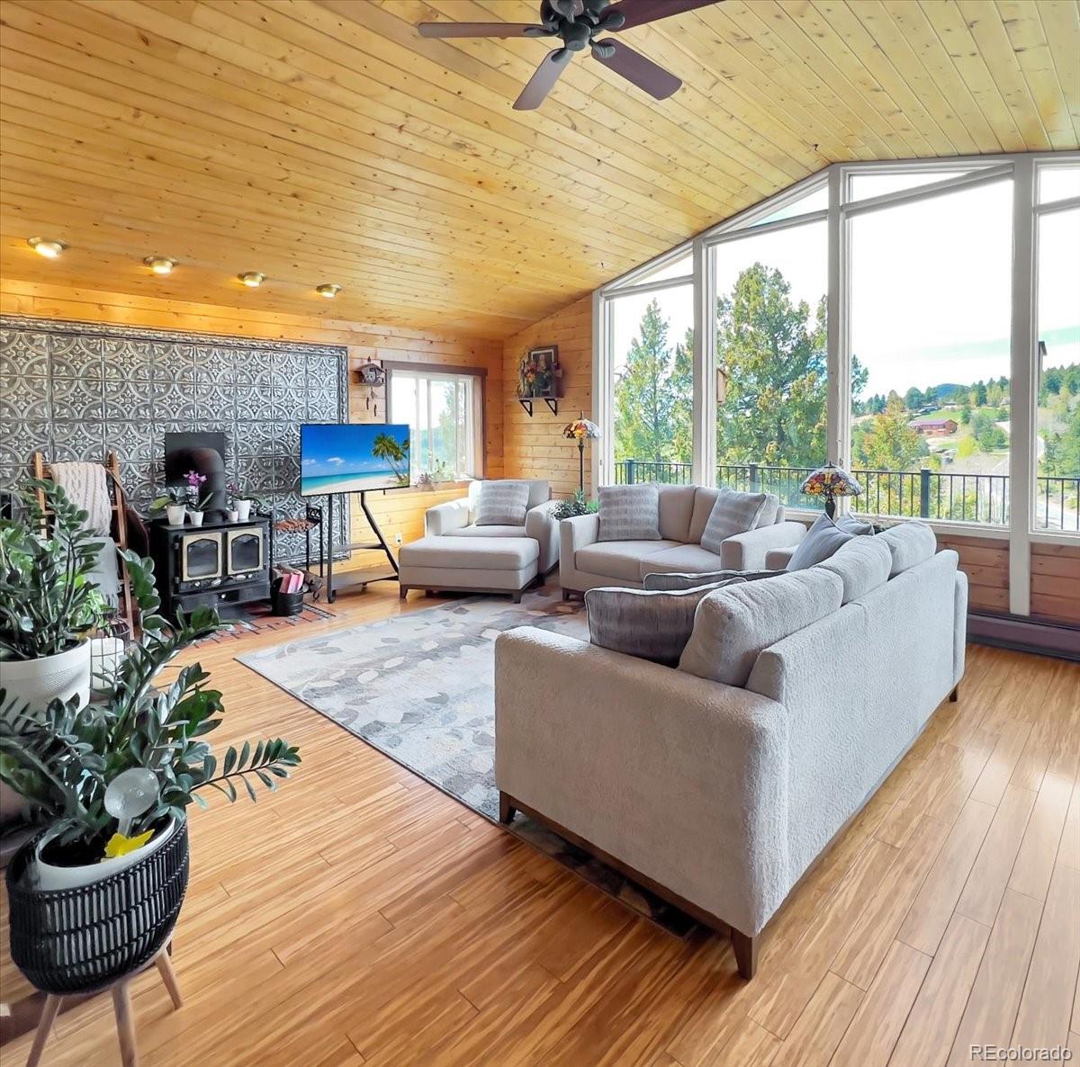 22155 Cook Lane Morrison, CO 80465 - Photo 3 of 28 a living room with furniture and a large window